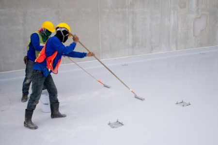 construction-worker-epoxy-painting-floor-water-proof-protection_33835-1022